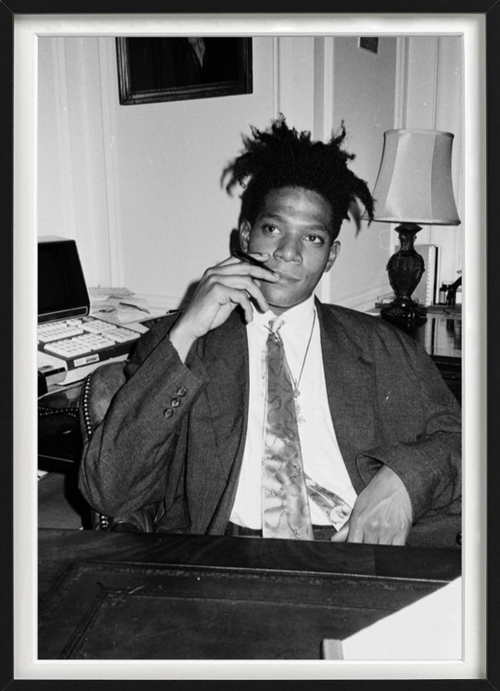 Black and white portrait of the young artist Jean-Michel Basquiat in a suit, sitting at a table, photographed by Roxanne Lowit in 1985.

All prints are limited edition. Available in multiple sizes. High-end framing on request.

All prints are done