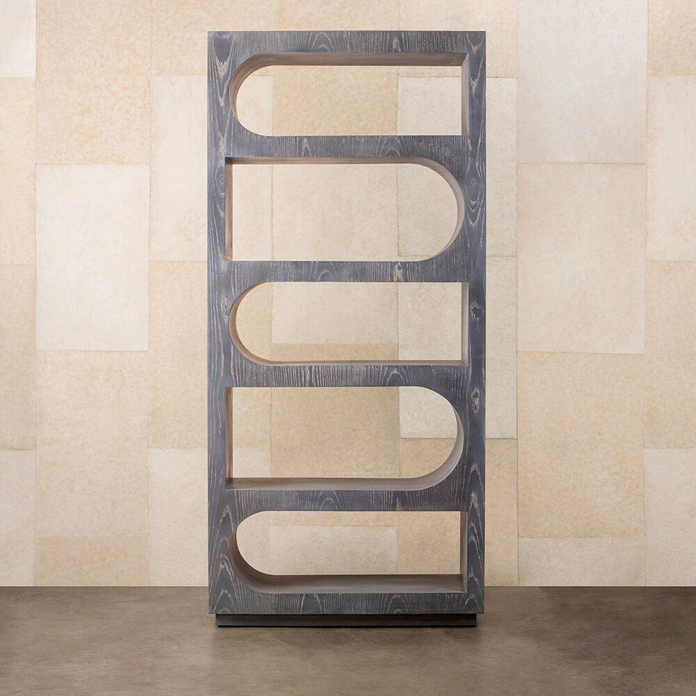 With its repetitive arches and monolithic scale, the Roxbury étagère celebrates a minimal, stylistic nod to classical architecture and form. This large shelving piece features a lightly wire-brushed cerused wenge body. This piece is also available
