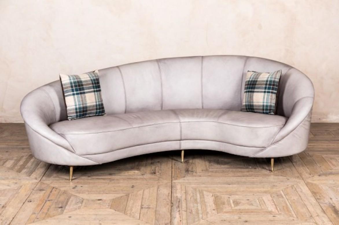 A fine Roxy real leather sofa, 20th century.

With a unique, curved, ‘kidney’ style shape, the Roxy sofa features real, full leather and aged brass feet, giving the sofa a midcentury style look.

The exquisite leather featured on the leather