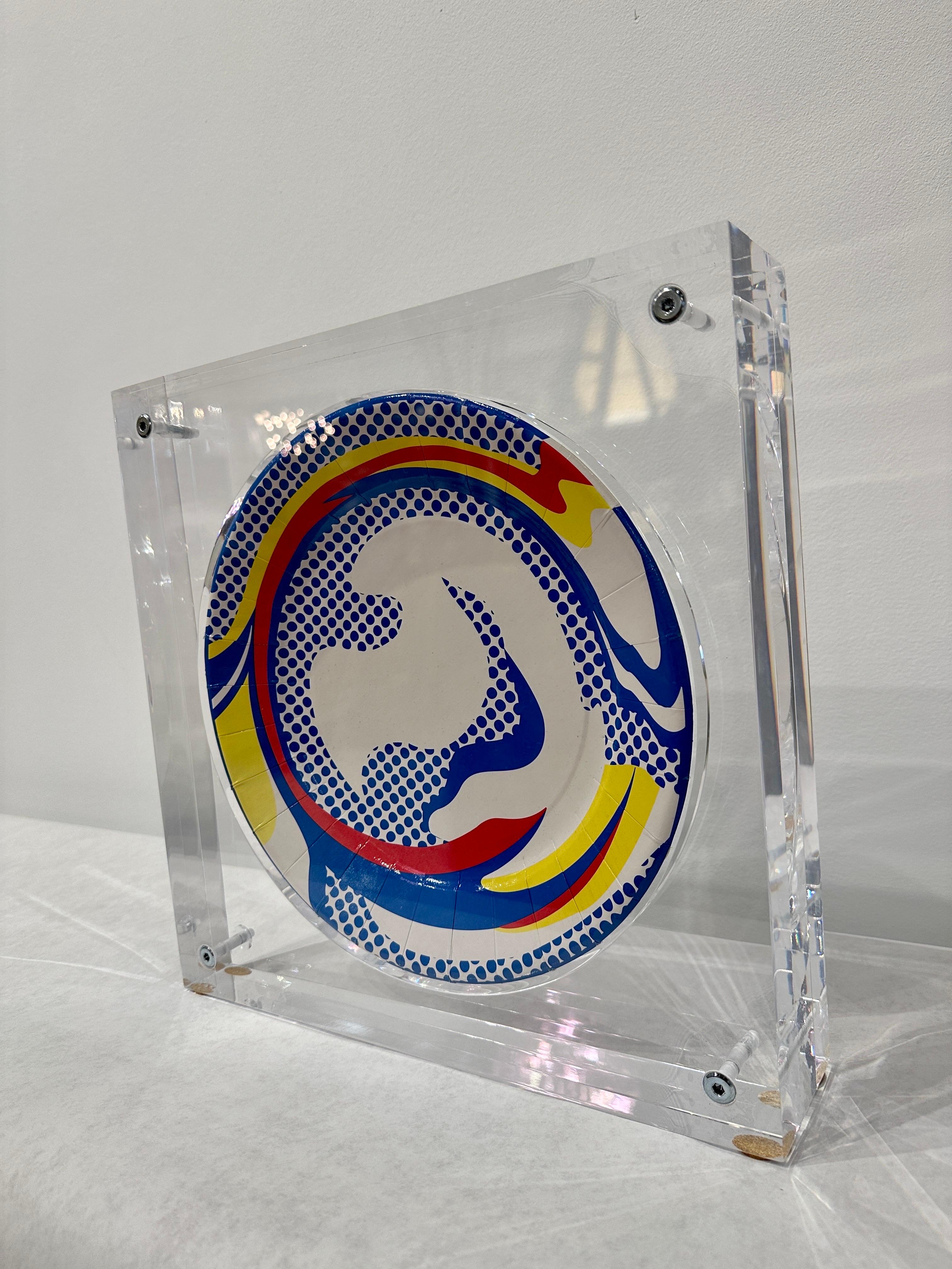 Created exclusively for Barneys of New York by the Estate of Roy Lichtenstein, the heavy and custom acrylic display box provides front and rear views of this master work. Stamped with artists signature on verso.

Dimension of plate is 11 inches.