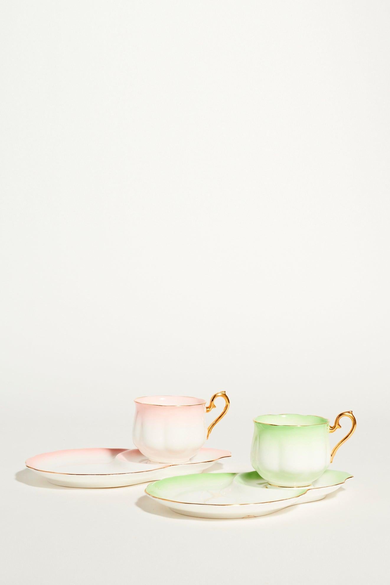Indulge your inner Bridgerton, English bone china tea set of two in whisper pink, delicate green and white accented with gilded handles and fine edging 

 