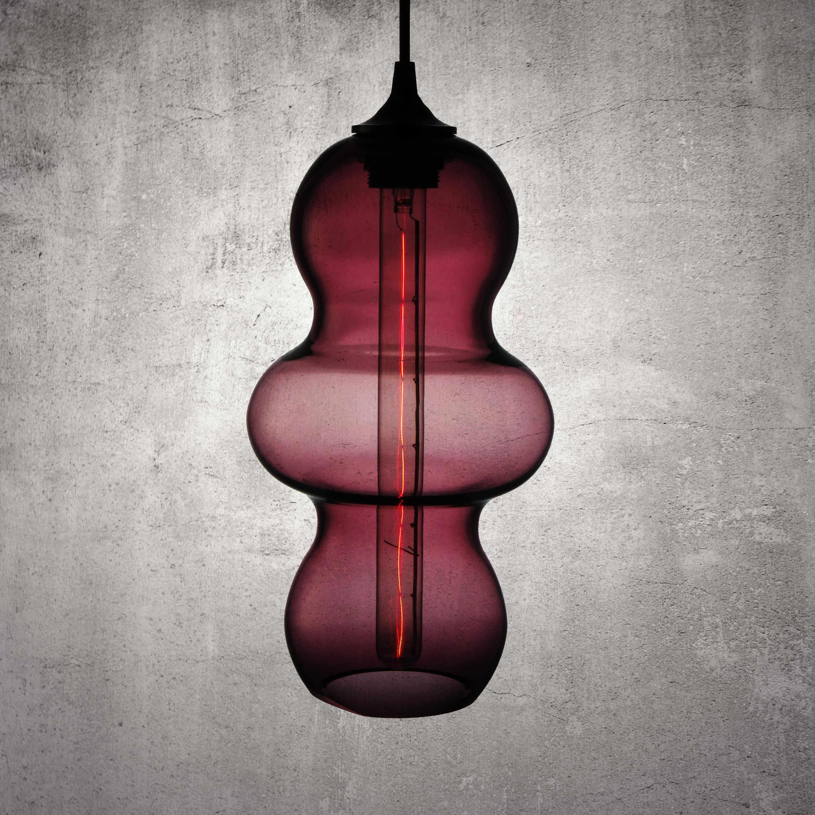 The Tamarindo contemporary glass pendant lamp is a contemporary interpretation of the tamarind fruit. Encapsulating its characteristics, the Tamarindo is sleek, curvaceous and light, hanging effortlessly with its long elongated form juxtaposed by a