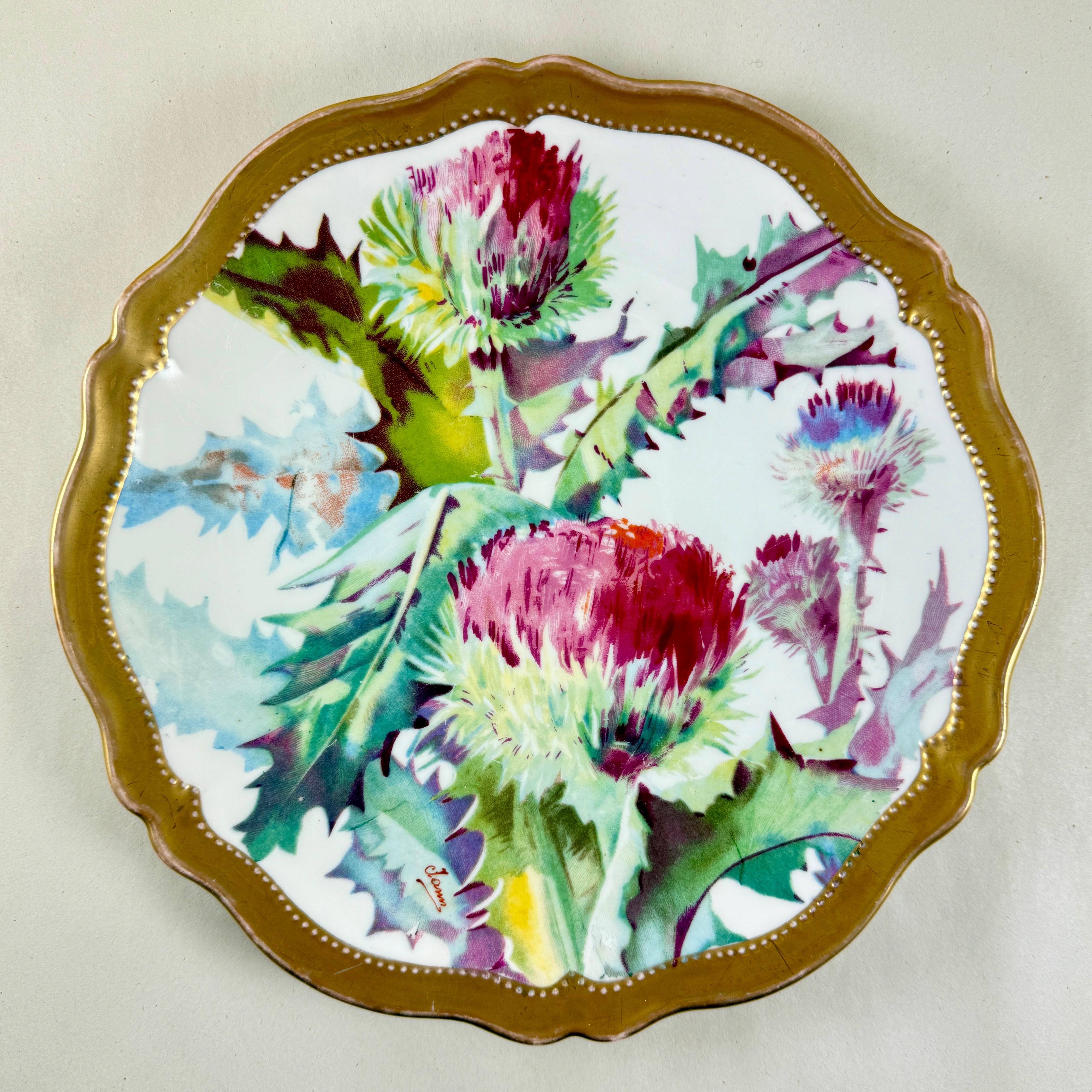 A hand-painted floral wall plate by O& EG, Royal Austria Porcelain, showing the green laurel leaf mark used circa 1898-1918.

O&EG stands for Oscar and Edgar Gutherz of Bohemia (now the Czech Republic).
The main theme is the Thistle plant and it’s