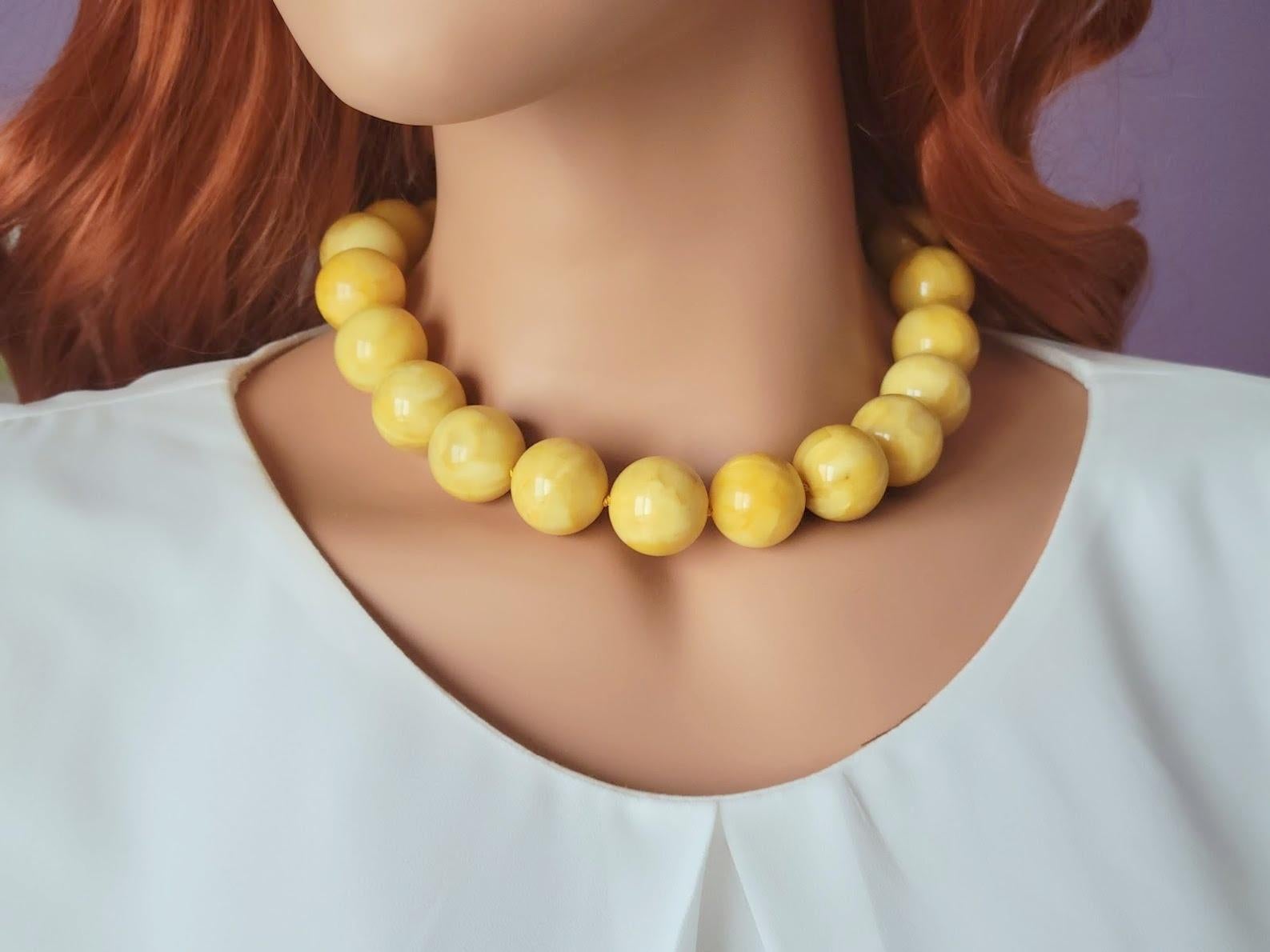 Introducing a one-of-a-kind piece of Baltic amber jewelry that is sure to take your breath away. This necklace is created from rare, colossal-sized round beads that vary in size from 20 to 21mm and measure a total length of 18 inches (45 cm).
The