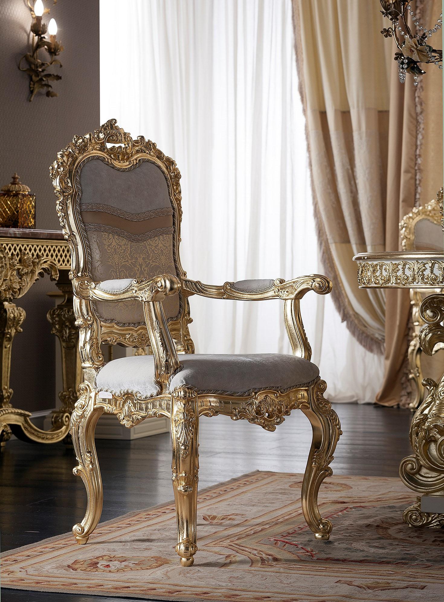 Enjoy your royal meal while sitting on this wonderfully upholstered chair with armrests by Modenese Gastone Interiors featuring a wood frame gold leaf applied in details, upholstered with a premium grey satin fabric. What's more? The incredibly