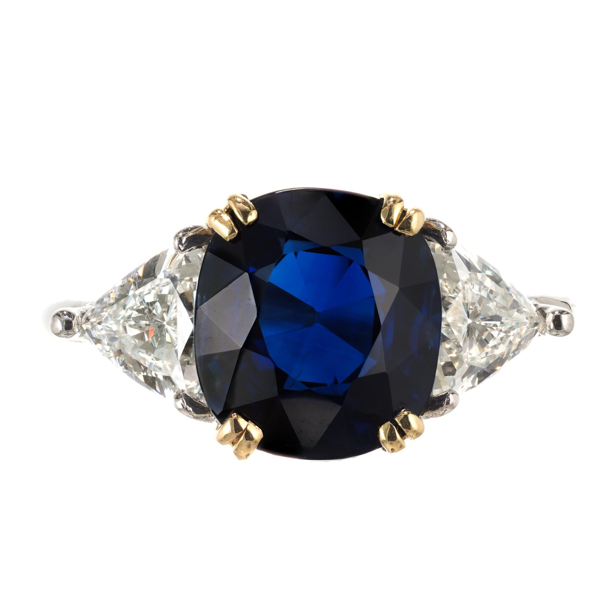 Rich Royal deep blue natural no heat Sapphire engagement ring in original handmade Platinum ring with 18k yellow gold center and bright white trilliant diamonds.

1 cushion Royal Blue Sapphire, approx. total weight 4.14cts, no heat, AGL certificate