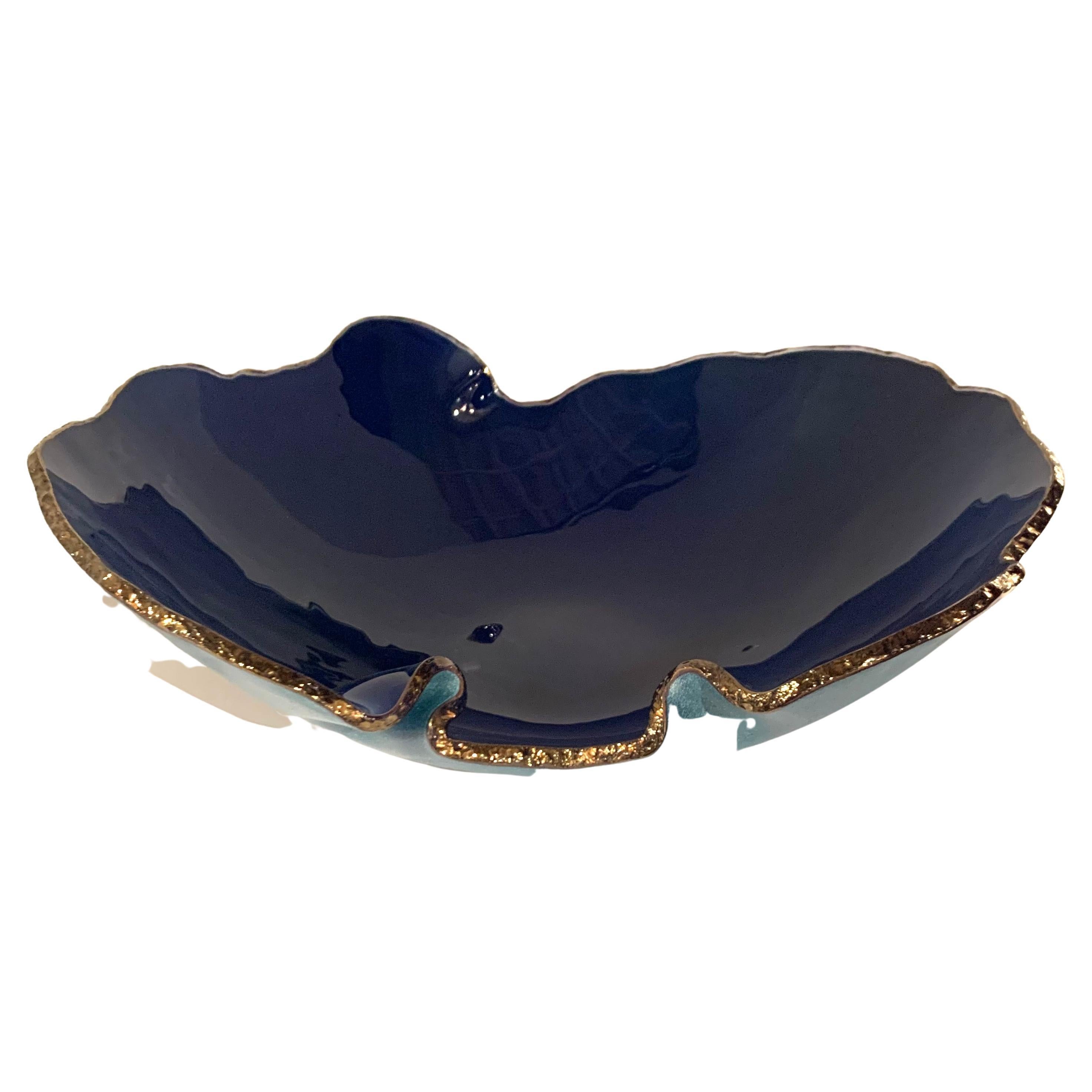 Contemporary Brazilian free form shaped glass bowl with royal blue interior
and washed blue exterior.
Decorative chiseled edge in gold.
One of several pieces from a collection of Brazilian designed glass objects.
