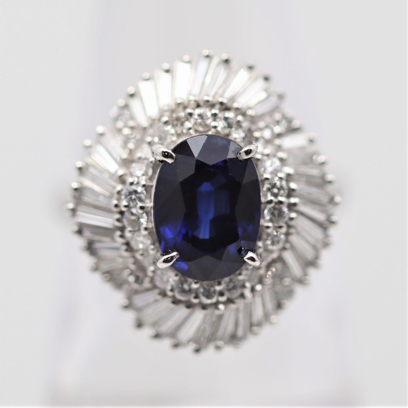 A lovely platinum ring featuring a fine oval-shape sapphire weighing 1.27 carats. It has a rich intense royal-blue color that is simply exceptional. It is set in the middle of a spray of diamonds, weighing 1.00 carat, and creating a ballerina style