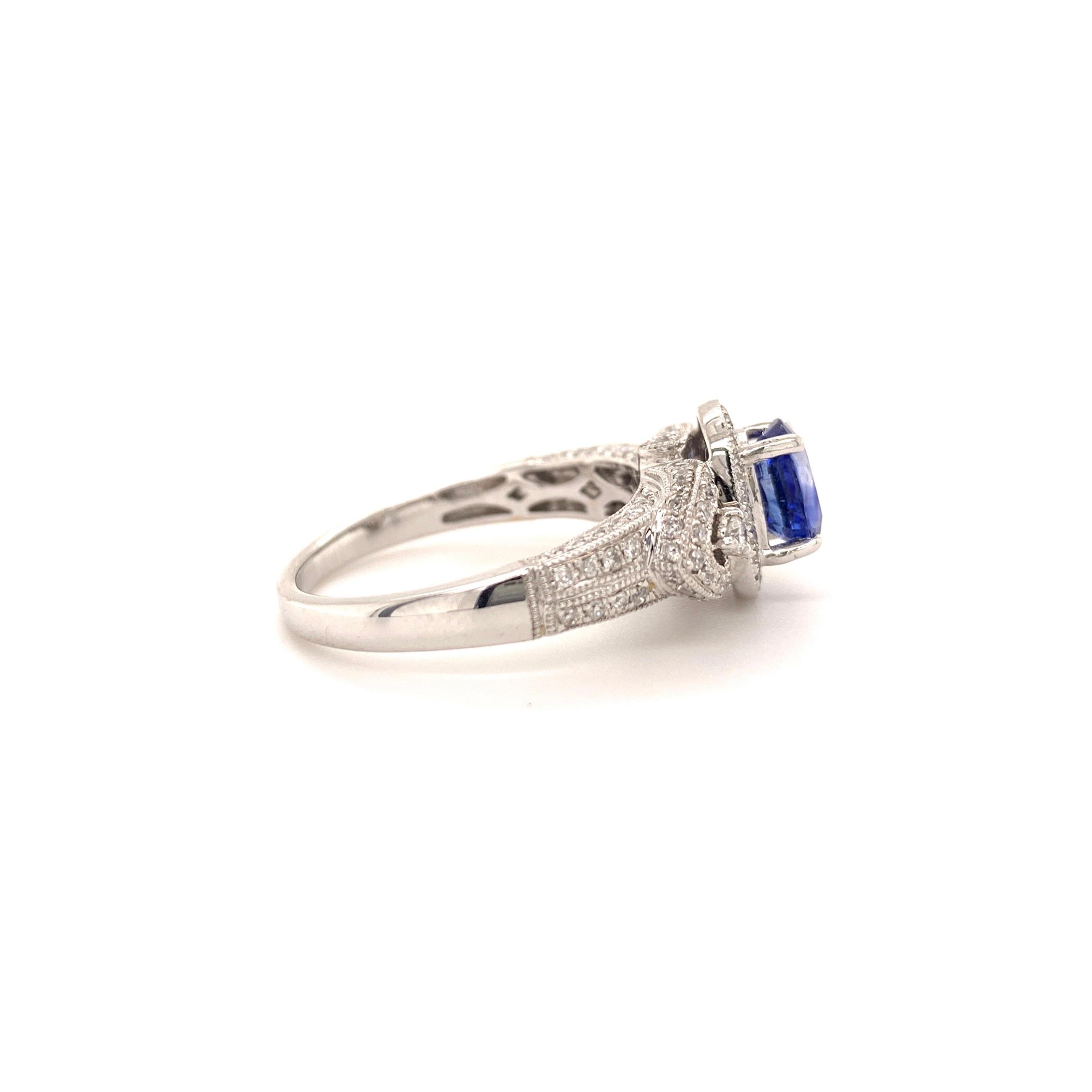 Elegant sapphire diamond ring. sparkling, oval faceted, lively blue 0.93-carat natural sapphire mounted in high profile basket with four bead prongs, accented with round brilliant cut diamonds. Handcrafted design set in high polished 14 karats white