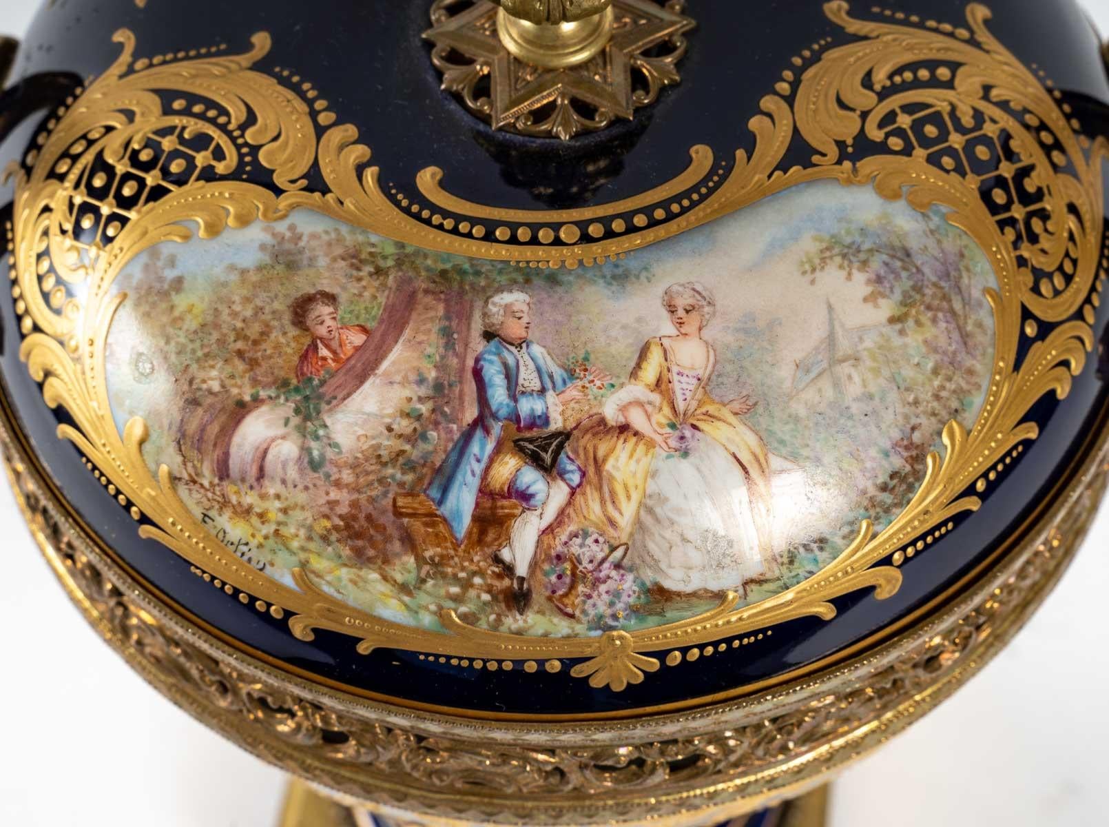 A royal blue Sèvres porcelain bonbonniere, richly decorated with gold and a gallant scene, mounted in gilt bronze, 19th century, Napoleon III period. Stamps of the Tuileries castle and Sèvres castle.