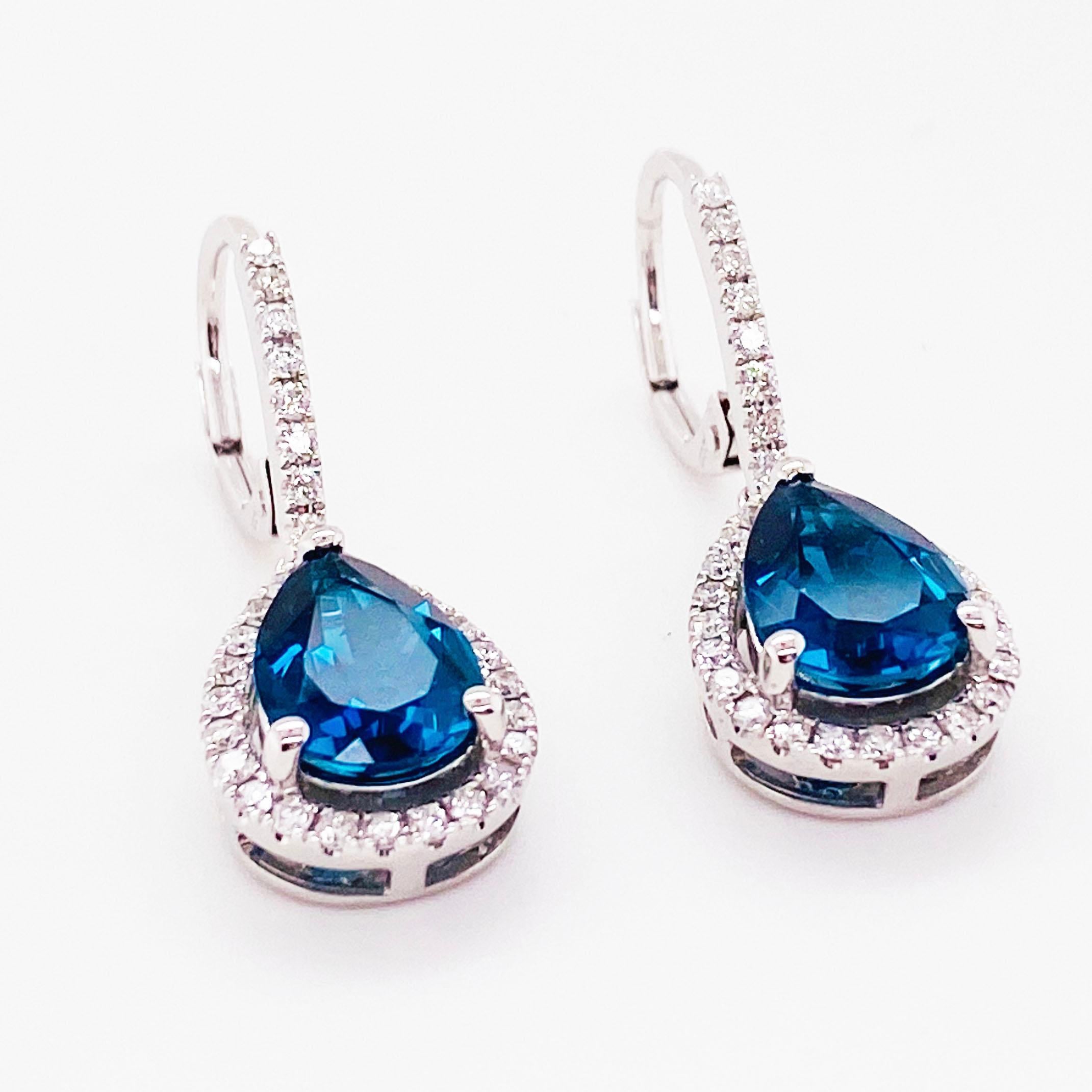 The royal blue topaz earrings are encrusted with diamonds all the way around like a halo setting.  These earrings look like Royalty with the London blue color of topaz!  The genuine gemstones are a teardrop or pear shaped cut.  There are eight