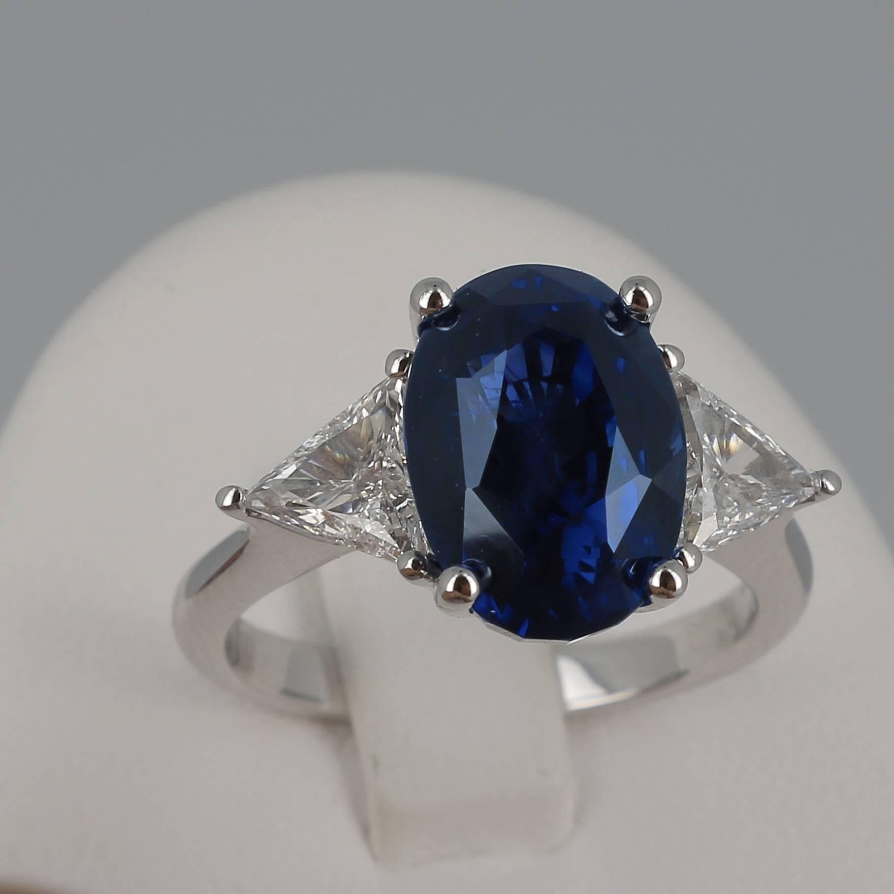 A Royal Blue Sapphire Ring weighing 8.34 carats. 
The stone’s shape is oval, with a striking Vivid Blue color type: Royal Blue.
The ring is set with two trapeze-cut Diamond weighing 0.85 Carats.
The Sapphire is accompanied by a certificate stating