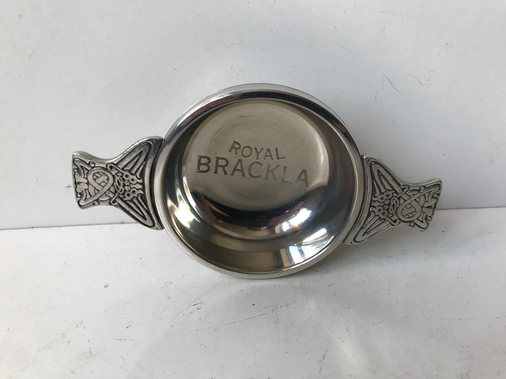 Royal Brackla makes some of the finest single malt whiskey in the world. This tasting vessel called a quaich is made from polished pewter and features handles with Celtic ornaments. In Scotland a quaich given as a gift symbolized friendship and
