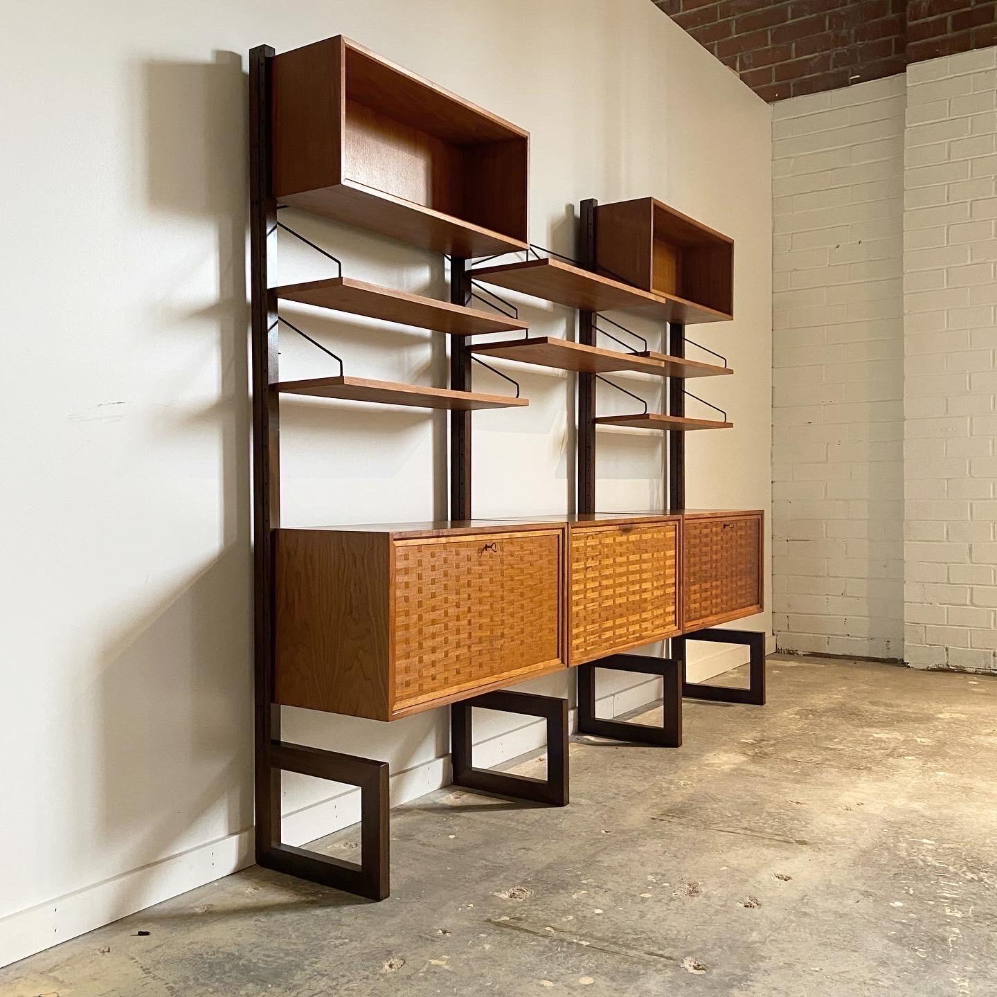 An excellent wall unit by Poul Cadovius. This piece is unique in that it is free standing and does not need to be wall mounted. Constructed of teak with woven pattern to the door fronts it has a striking look. Can be reconfigured how you like with