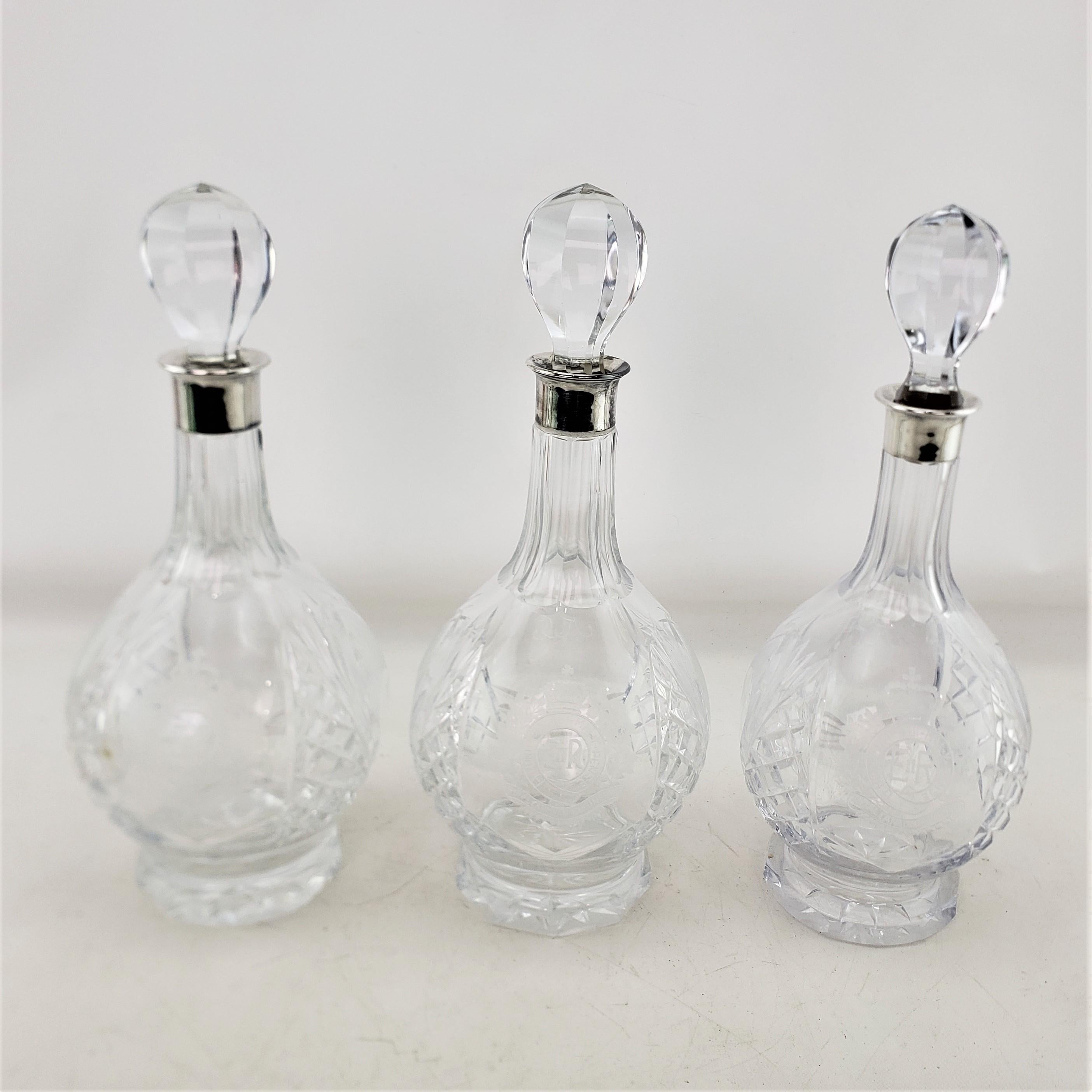 These quite heavy and well executed bottle decanters are possibly hallmarked by an unknown maker, but presumed to have originated from Canada and date to approximately 1970 and done in a period midcentury style. The decanters are composed of lead