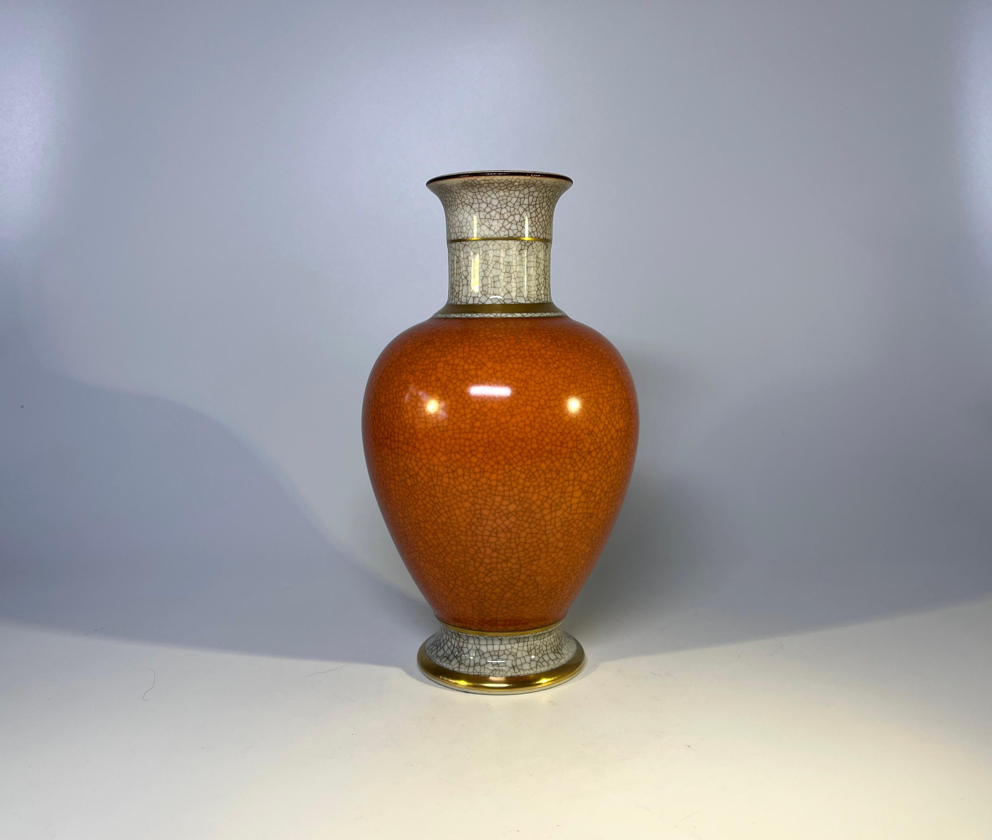 Elegant terracotta orange and grey porcelain, Royal Copenhagen crackle glazed vase with gilded banding on neck and base.
Circa 1956
Stamped and numbered 3032
Measures: height 7 inch, diameter 4 inch
Excellent condition.