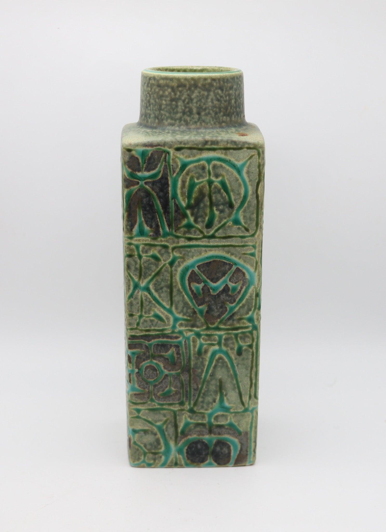 A square green glazed vase designed by Nils Thorsson (1898-1975) for Royal Copenhagen.

This is a very decorative vase created in Copenhagen Denmark by the Royal Copenhagen porcelain company, back in 1960. Designed with abstract patterns by Nils