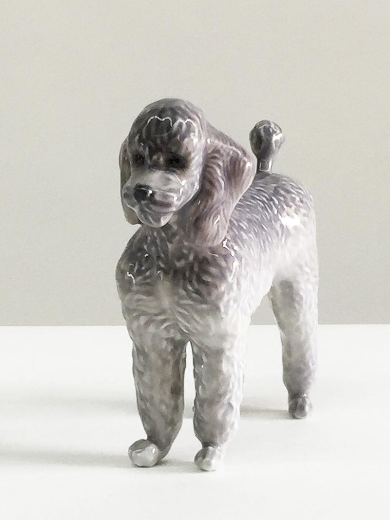 Royal Copenhagen #4757, dog figurine, Denmark

A porcelain poodle designed by Jeanne Grut for Royal Copenhagen Denmark
The production is stopped in 1984
Numbered with #4757

And under glazed not colored letters JG (Jeanne Grut)

The