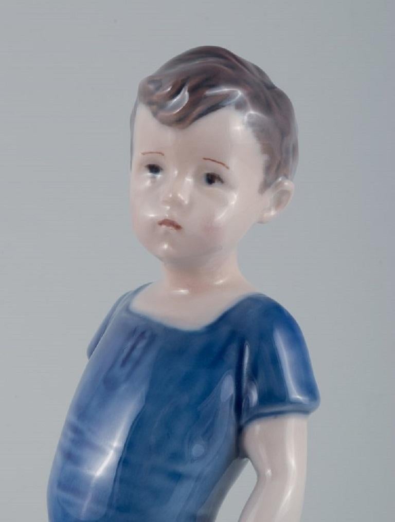 Contemporary Royal Copenhagen, a Rare Figure of a Boy, Model Number 519 For Sale
