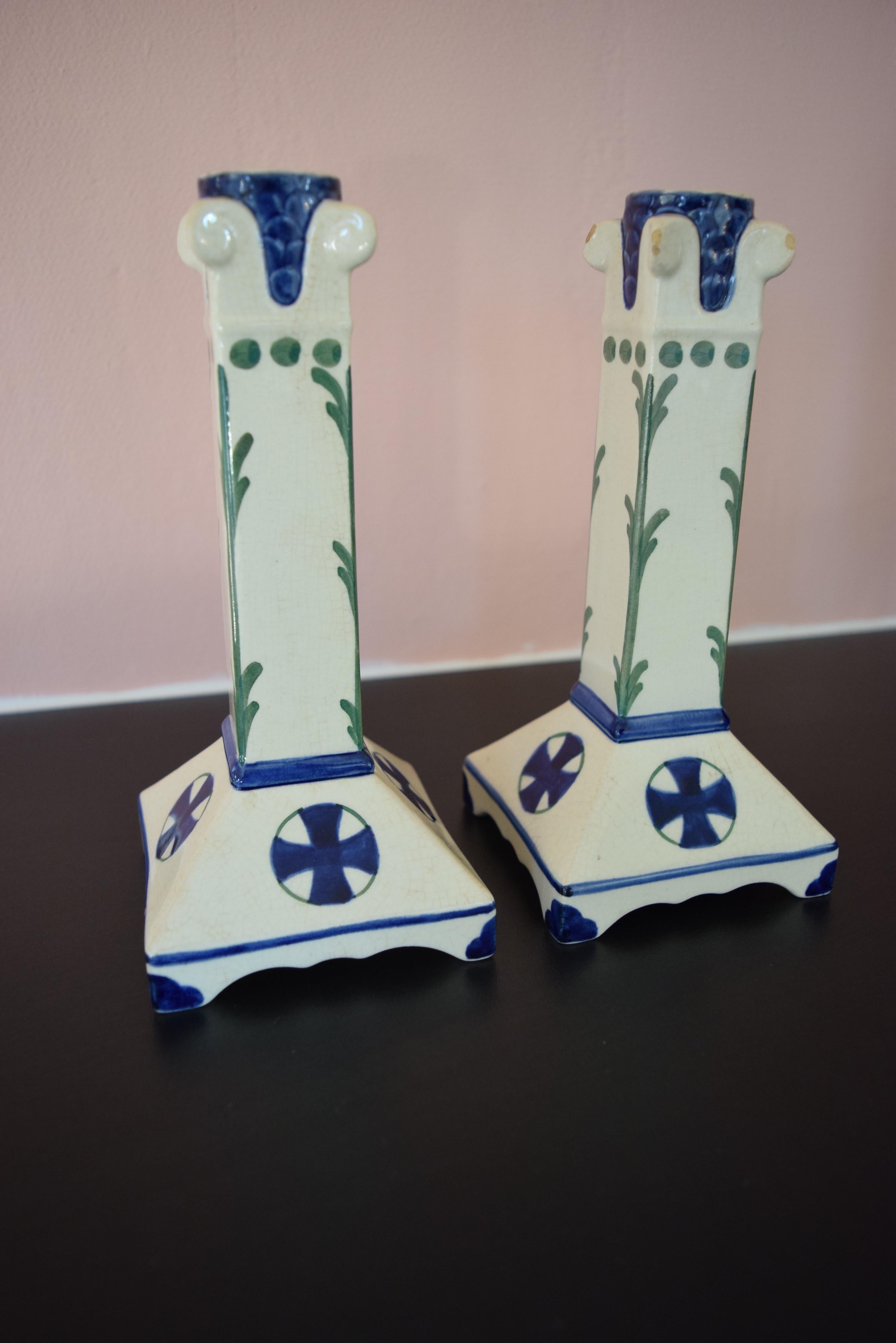Royal Copenhagen Aluminia candlesticks made of faience with Classic Aluminia decoration in blue and green. Marked at the bottom A and 478/422, Copenhagen Denmark. Pre 1906.