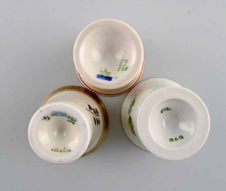 Porcelain Royal Copenhagen and Bing & Grøndahl. Five egg cups in hand-painted porcelain. For Sale