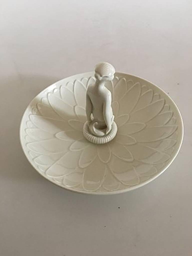 Royal Copenhagen Arno Malinowski dish with figurine of a girl #12481. Measures 16 cm and is in good condition.