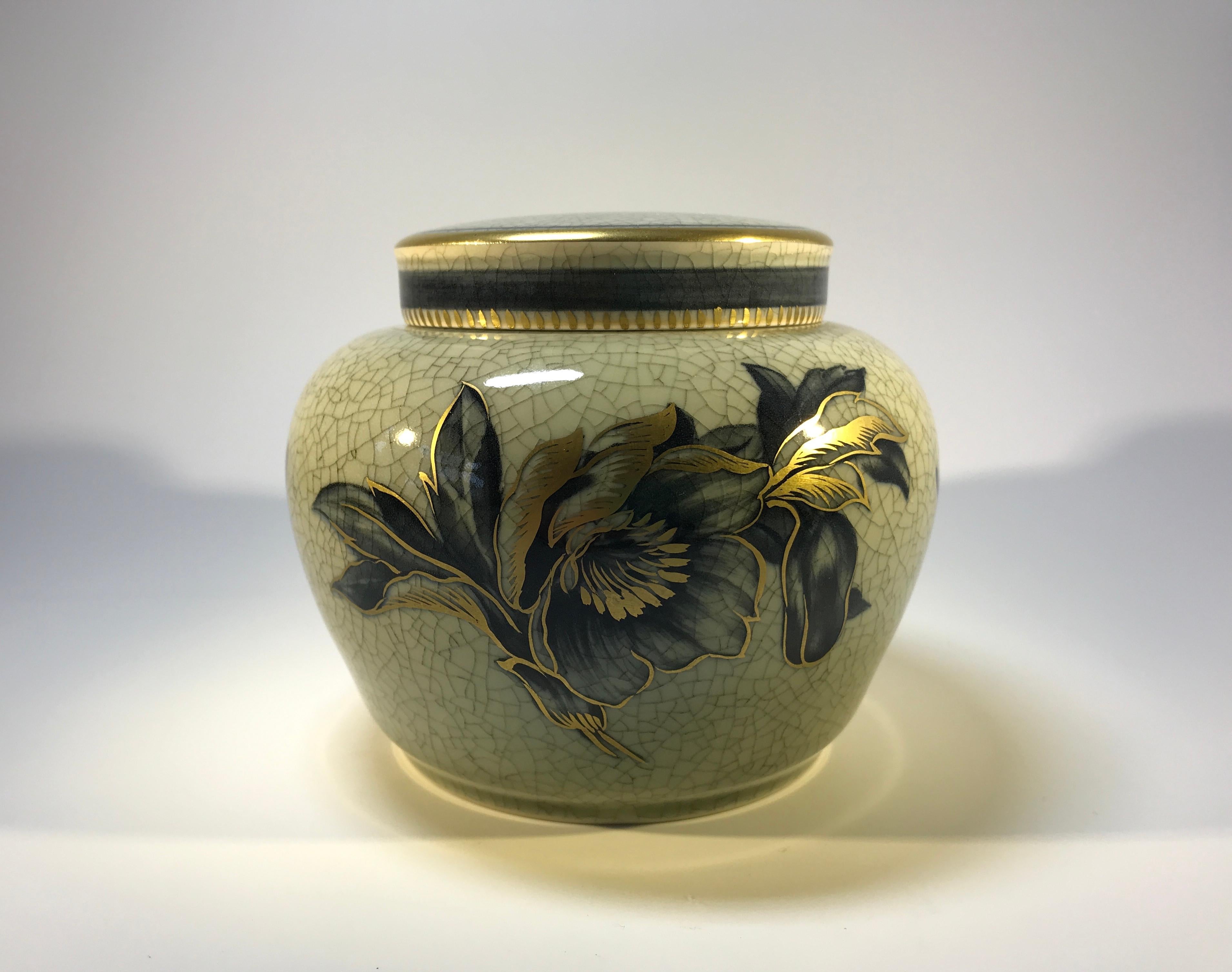 Royal Copenhagen lidded ginger jar with large gilded floral decoration and gilded banding. In Art Deco style this piece has a moss green crackle effect to the glaze.
Signed and numbered 2687 on lid and base
In very good condition.
         