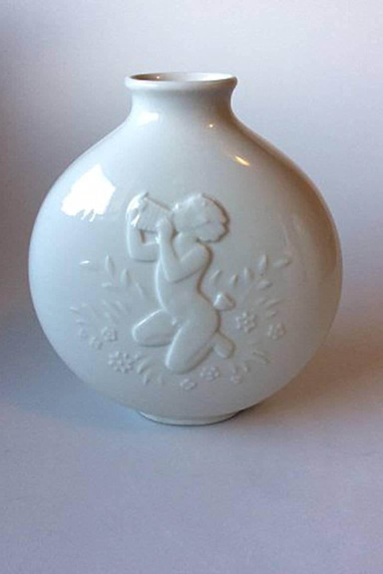 Royal Copenhagen blanc de chine vase by Hans Henrik Hansen of a nude girl and faun No. 4177
Measures 19.5 cm / 7 2/3 inches high and 17 cm / 6 7/10 inches wide.