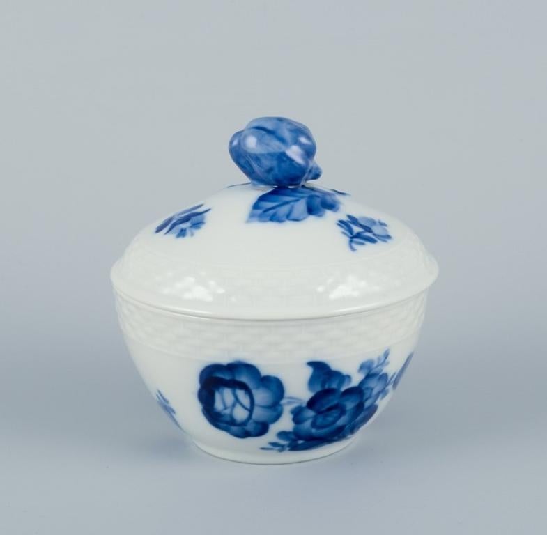 Royal Copenhagen Blue Flower Braided. 
A sugar bowl and a bouillon cup.
Model 10/8081 + 10/8205-8211.
Dated 1965 and 1958.
First factory quality.
Marked.
In perfect condition.
Sugar bowl: Height 8.5 cm x Diameter 9.0 cm.
Bouillon cup: Height 8.0 cm