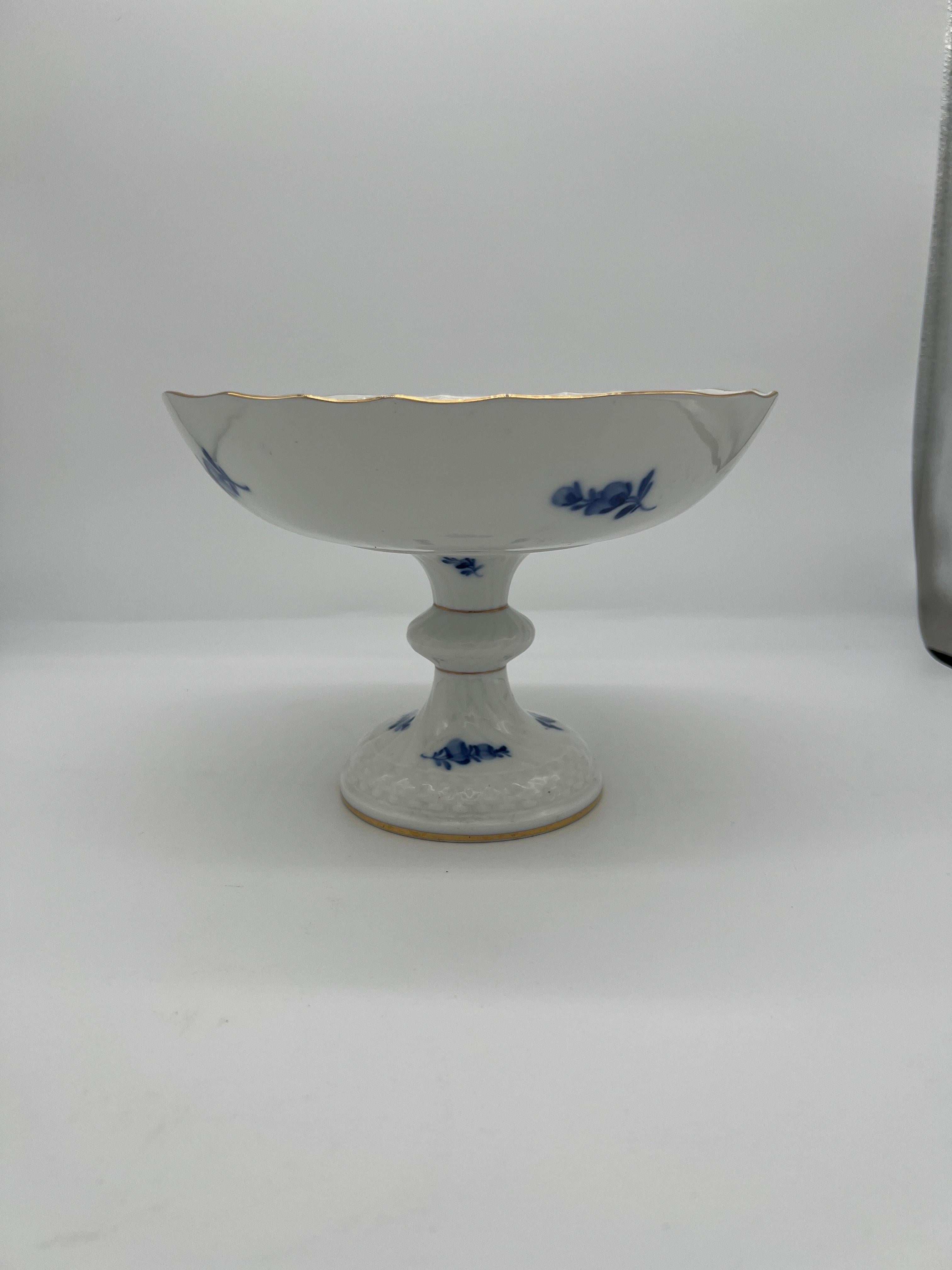 Royal Copenhagen (Danish, founded 1775), circa 1970.

A vintage Royal Copenhagen porcelain compote or cake stand. The piece features a swirl effect to the construction, gold detail to the scalloped rim and foot and a beautiful blue and white floral