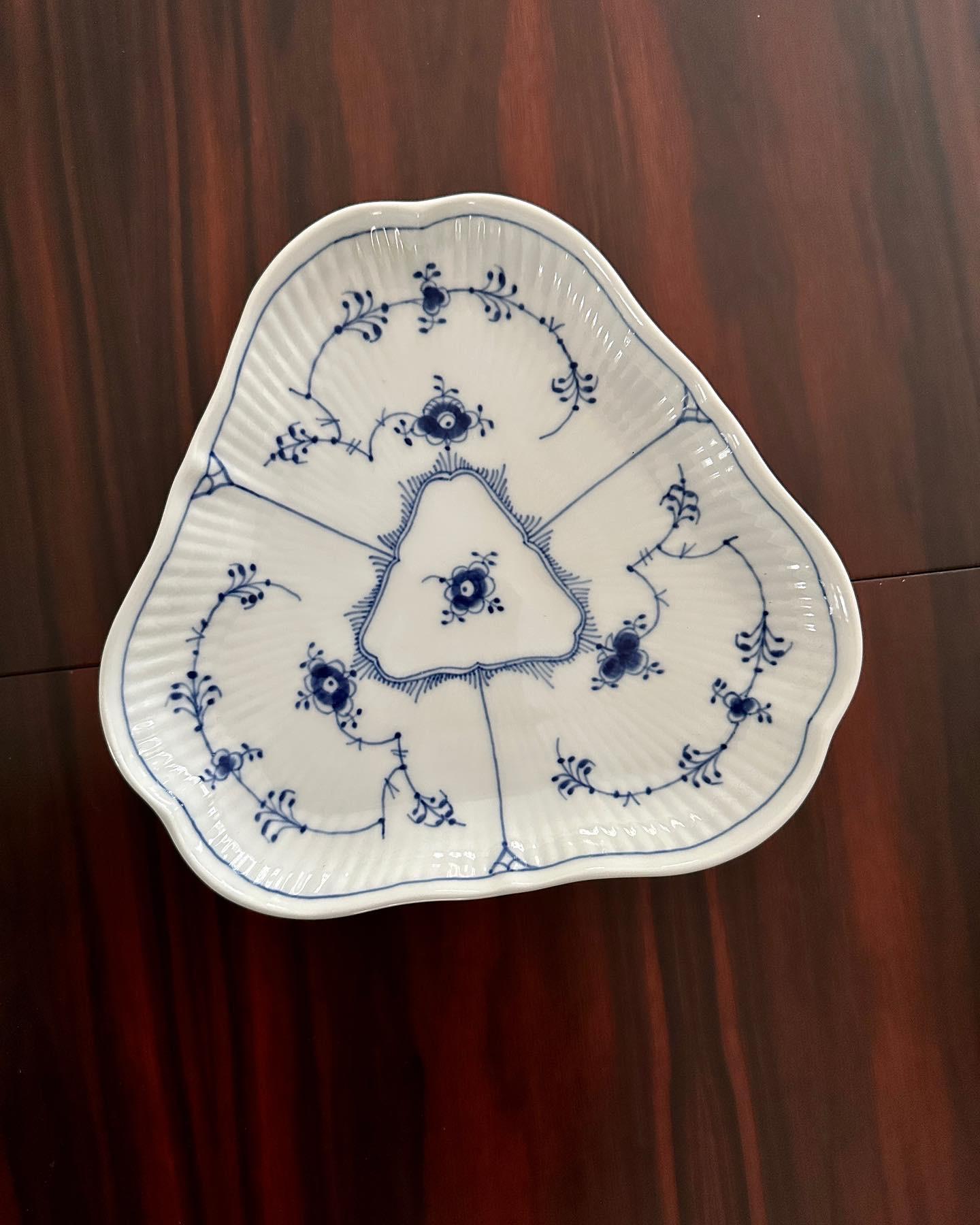 A blue/white fluted pickle dish from Royal Copenhagen.  The design was based on an antique chinese pattern and was created in 1775 by Royal Copenhagen.  Arnold Krog, the artistic director of Royal Copenhagen from 1884 to 1916, revised the design in