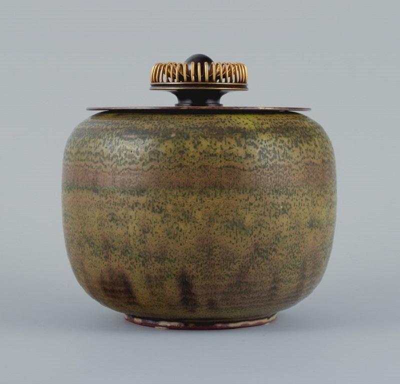 Royal Copenhagen, ceramic lidded jar solfatara glaze and bronze lid by Knud Andersen for Royal Copenhagen.
Approx. 1930.
Marked.
First factory quality.
In perfect condition.
Dimensions: H 18.0 x D 15.0 cm.