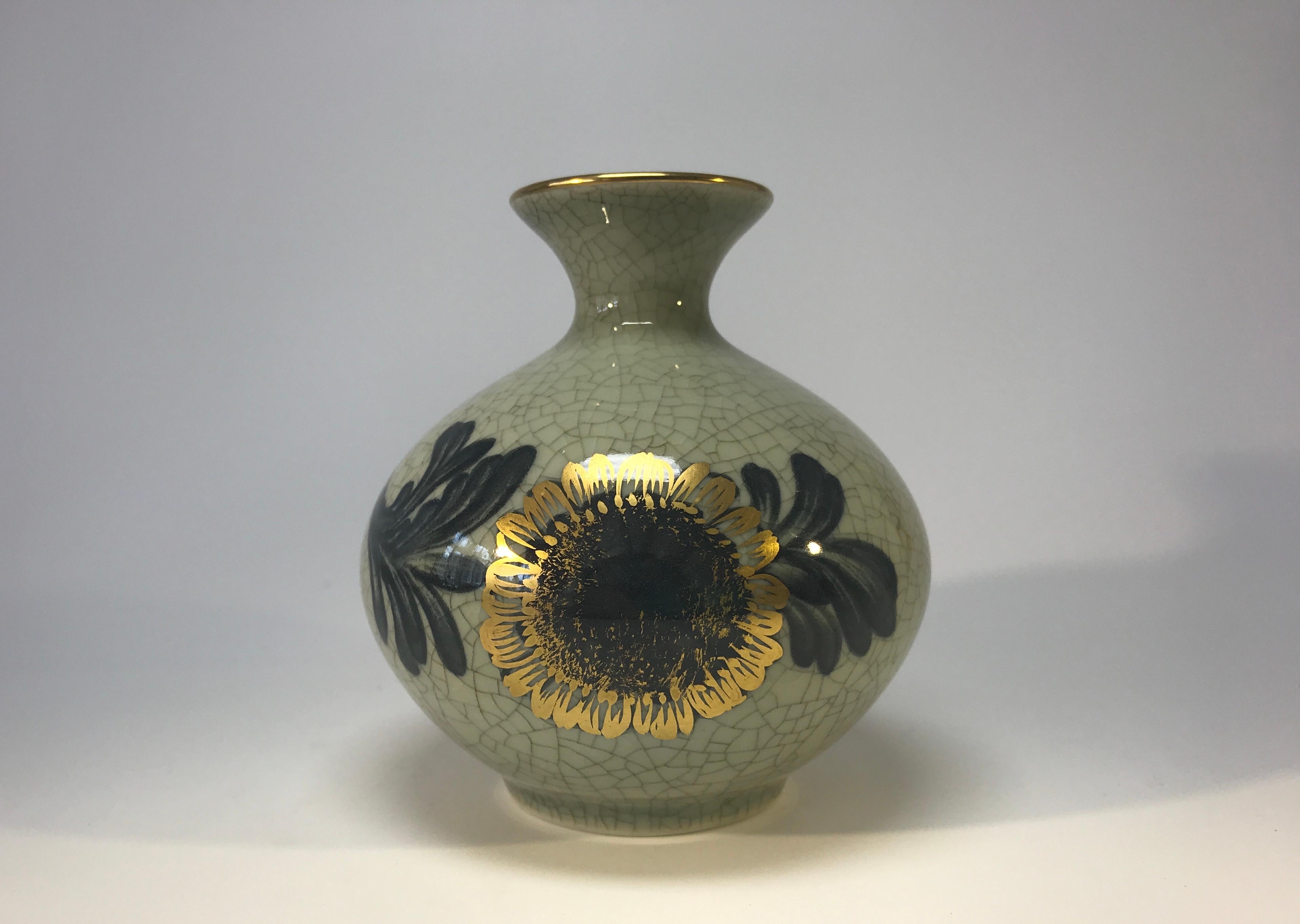 Royal Copenhagen porcelain sage green crackle vase with gilded sunflower decoration and gilded banding on rim,
circa 1961
Stamped and numbered 2353
Measures: Height 4 inch, diameter 3.5 inch
In excellent condition.
 