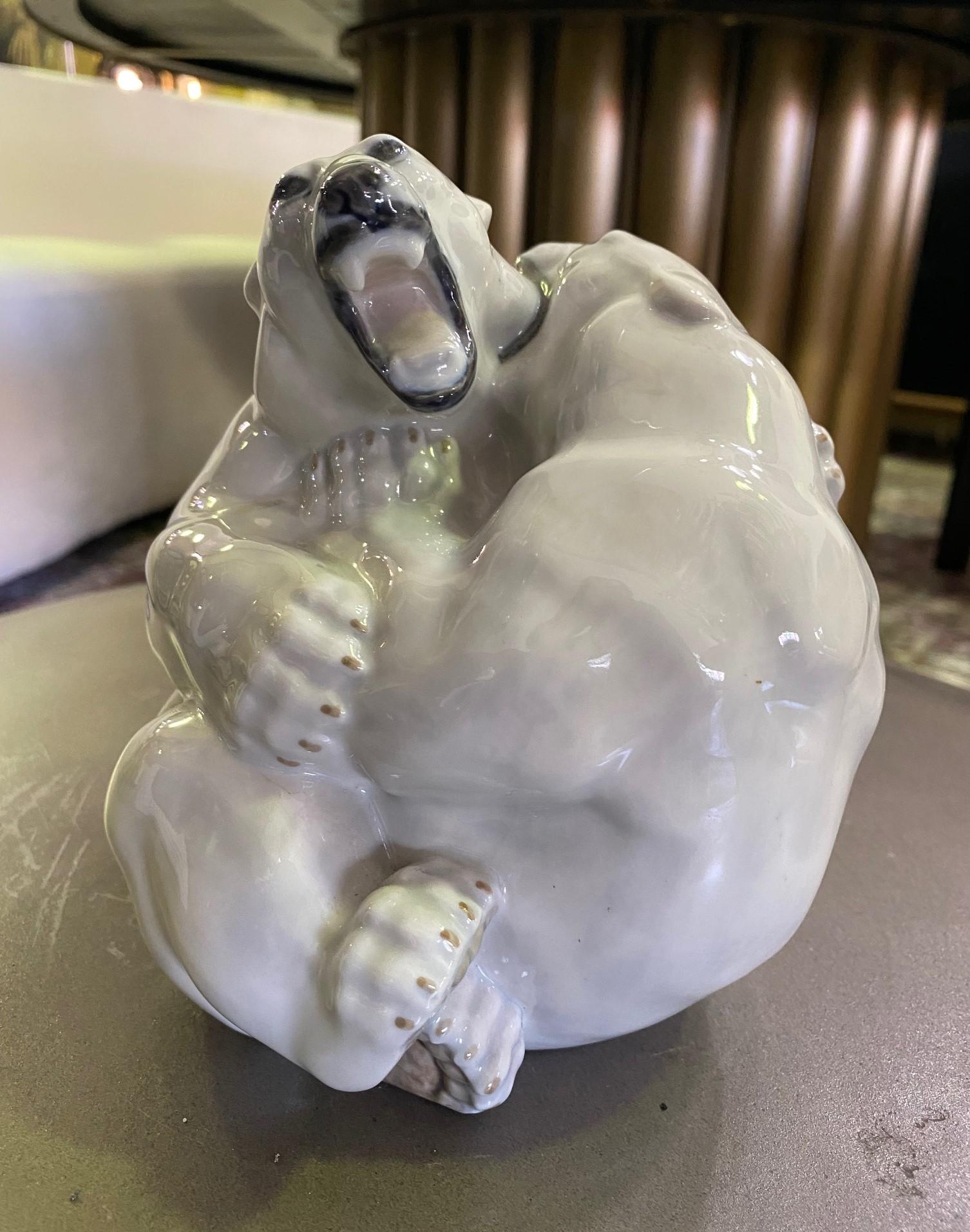A wonderfully designed and colored figurine of two playful fighting/wresting polar bears by Danish Royal Copenhagen. 

Stamped, numbered (2317), and signed (