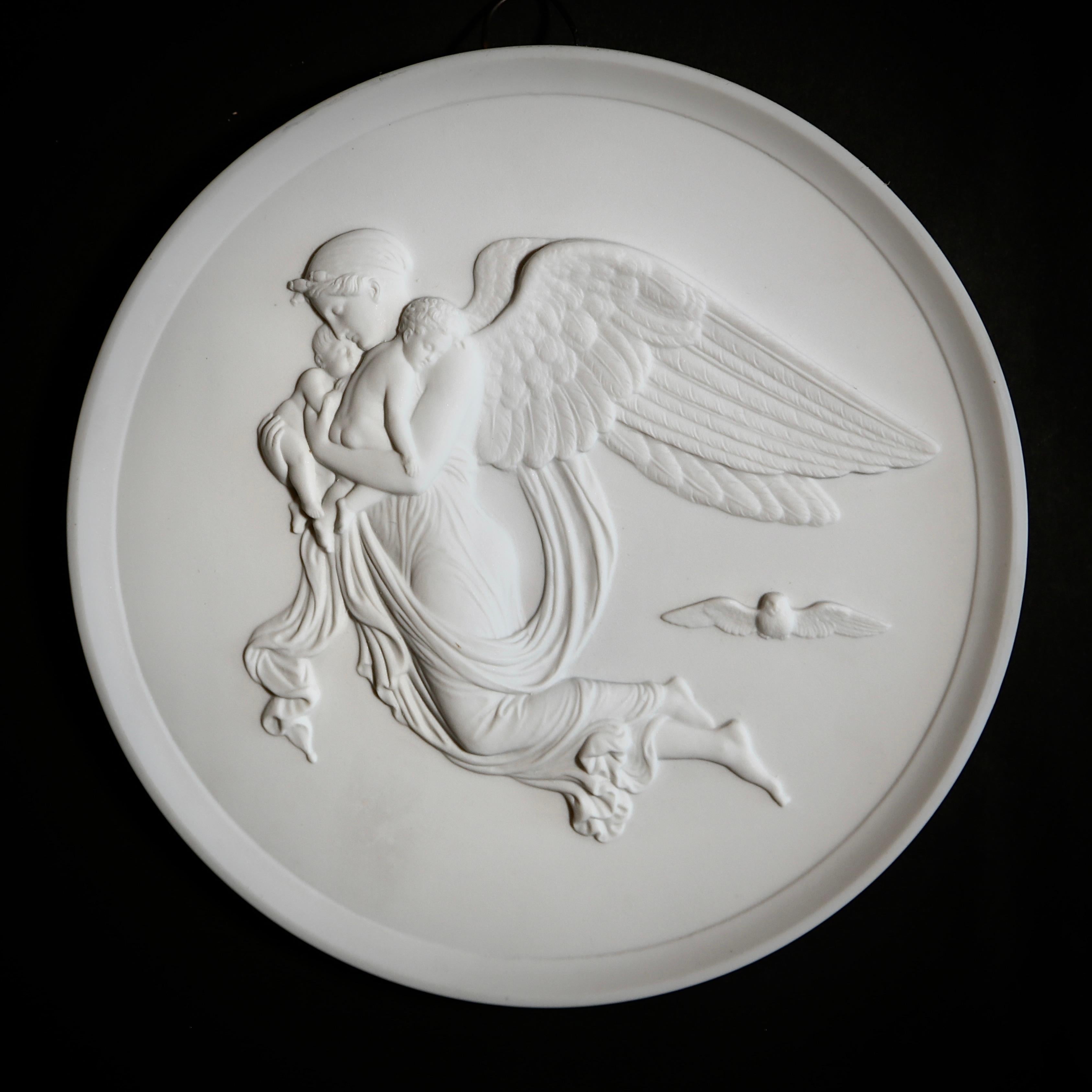 Pair of extra fine Royal Copenhagen bisque porcelain relief plaques fashioned to represent the marble originals by Bertel Thorvaldsen (1770-1844) of the Angel of Night, with her children, sleep and death; and of the Angel of Day, with the Genius of