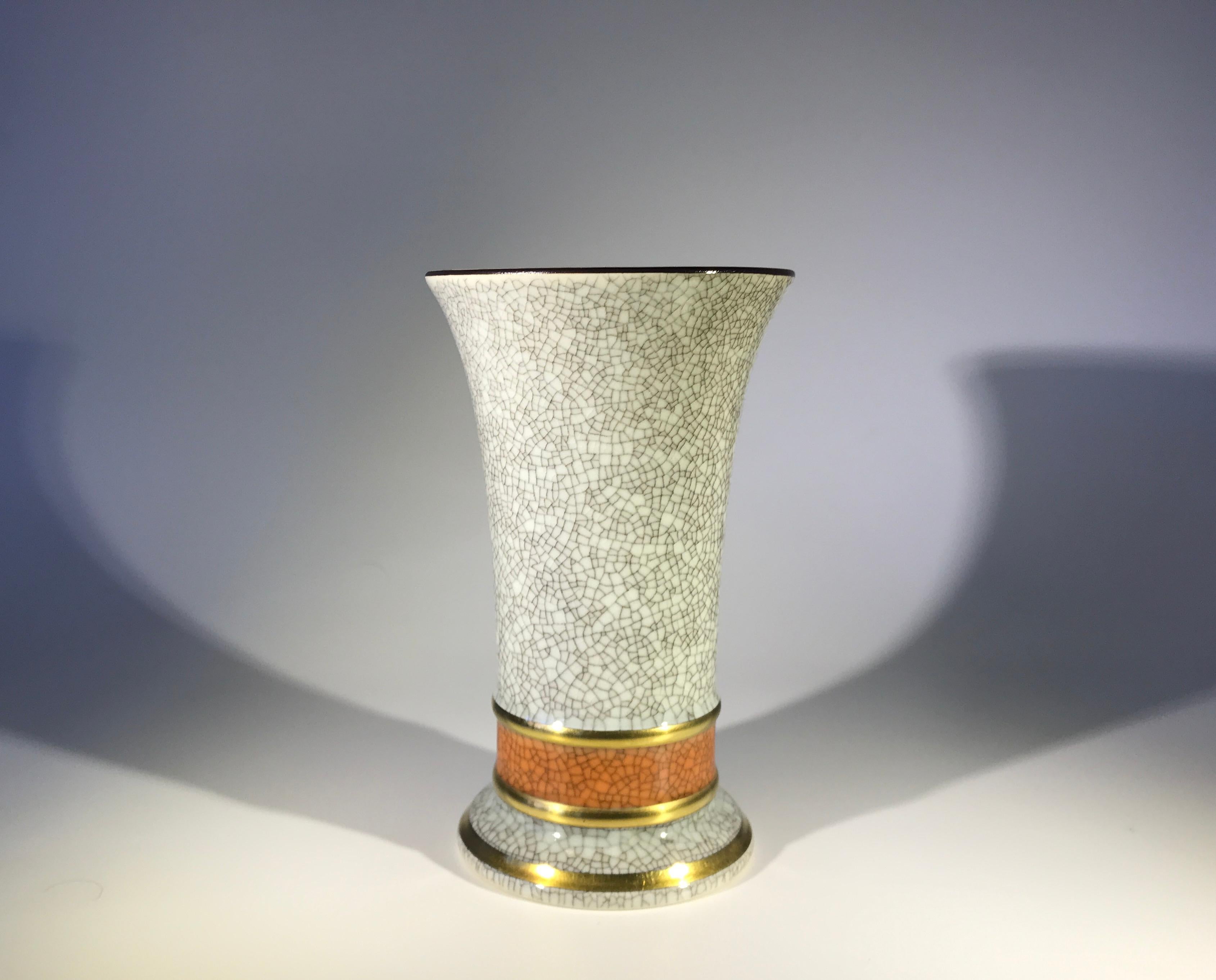 Royal Copenhagen of Denmark, porcelain fluted grey crackle glazed vase with terracotta and gilded banded decoration,
circa 1961
Made in Denmark
Stamped and numbered 3462
Measures: Height 5.5 inch, diameter 3.25 inch approximate
Very good