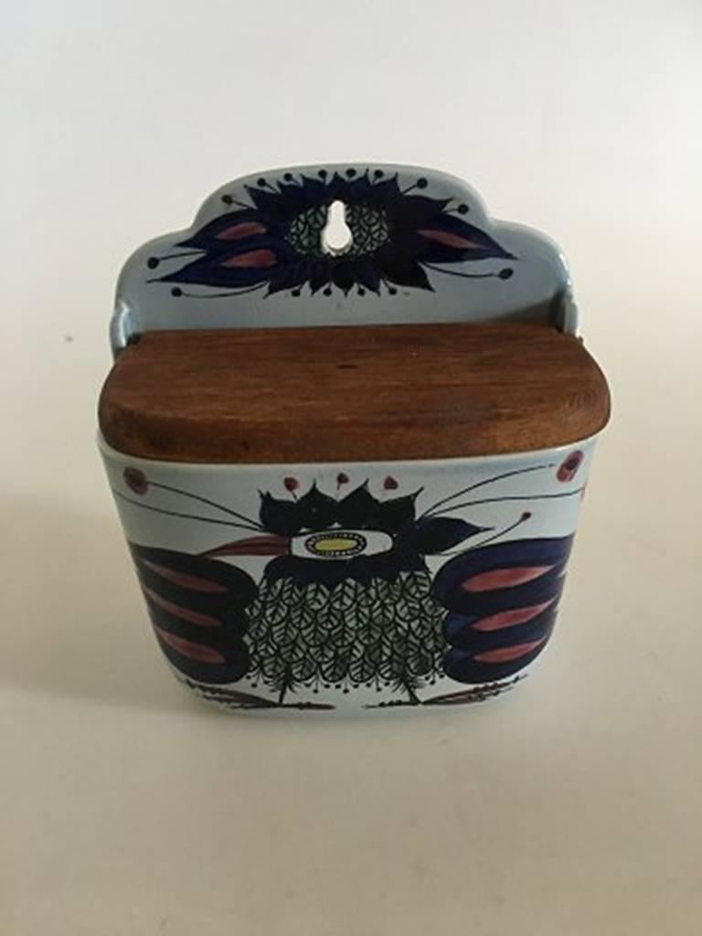 Royal Copenhagen earthenware salt jar with wooden lid no. 180/261 for wall display. In good condition.