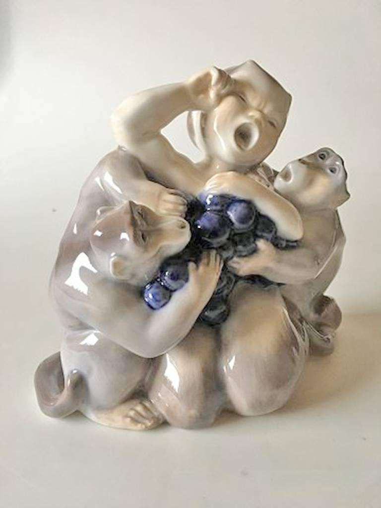 Royal Copenhagen faun/pan figurine with two monkeys #2496. Measures: 21cm x 18cm. First quality and designed by Knud Kyhn.