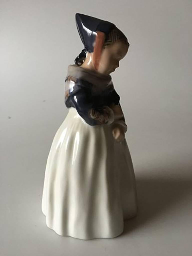 Royal Copenhagen figurine Amager girl #1251. Measures 20cm and is in good condition. Designed by Lotte Benter.