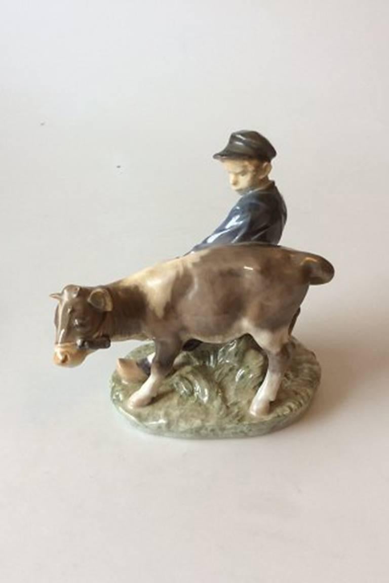 Royal Copenhagen figurine boy with calf #772. Measures: 17cm x 18cm and is in good condition.