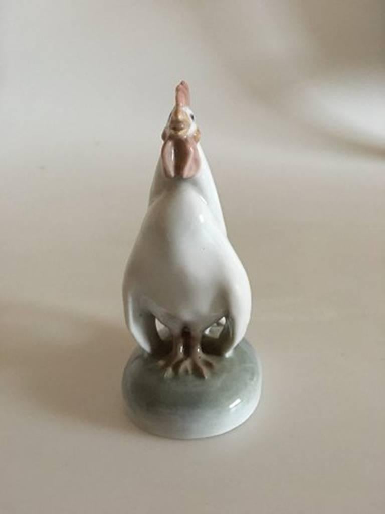 Royal Copenhagen figurine cock with head up #1126. Measures 11 cm x 8 cm and is in perfect condition.