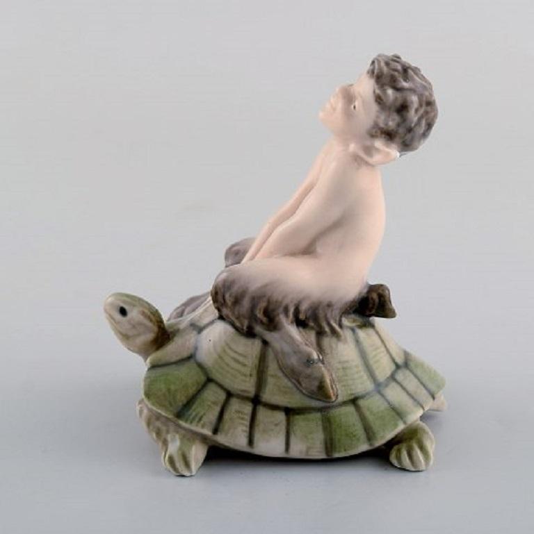 Royal Copenhagen figurine faun (Pan) on a turtle.
Design: Christian Thomsen.
Decoration number 858.
Size: Height 9 cm.
In very good condition.
4. Factory quality.