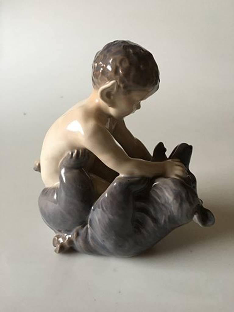 Royal Copenhagen figurine faun with bear #648. Measures 16 cm and is in good condition.