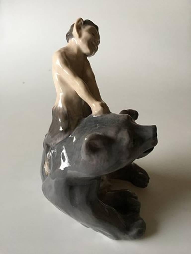 Royal Copenhagen figurine faun/pan pulling bear ear #1804. Knud Kyhn design and measures 19cm. First quality.