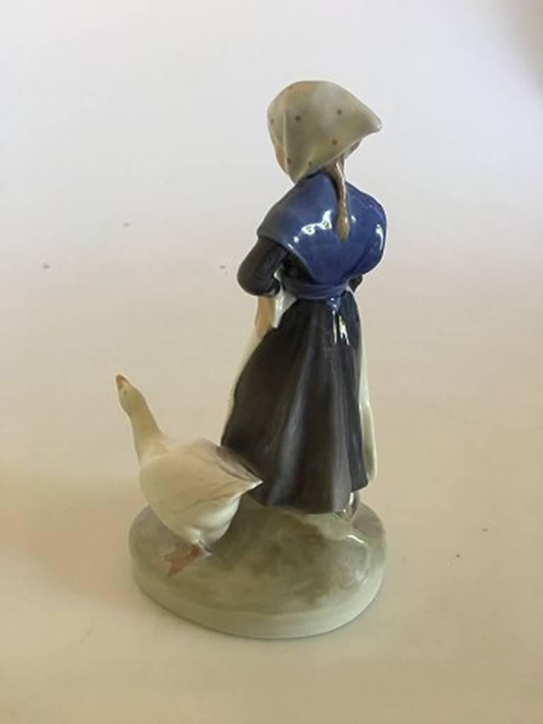 Royal Copenhagen figurine no. 528. Girl with goose. Measures: 18 cm H. In nice whole condition.