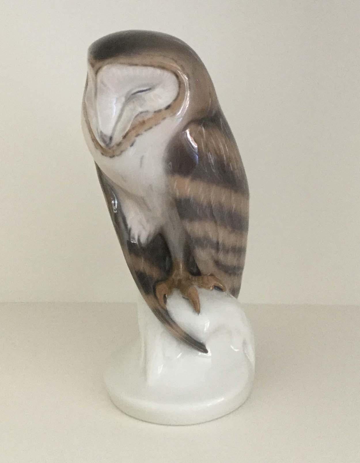 Royal Copenhagen barn owl porcelain figurine, modeled by Christian Thomsen in 1900, marked to the base with the factory mark of 3 wavy blue lines and, in green, 'Royal Copenhagen Denmark'. Also, bears model number 273 and the artists initials FG.