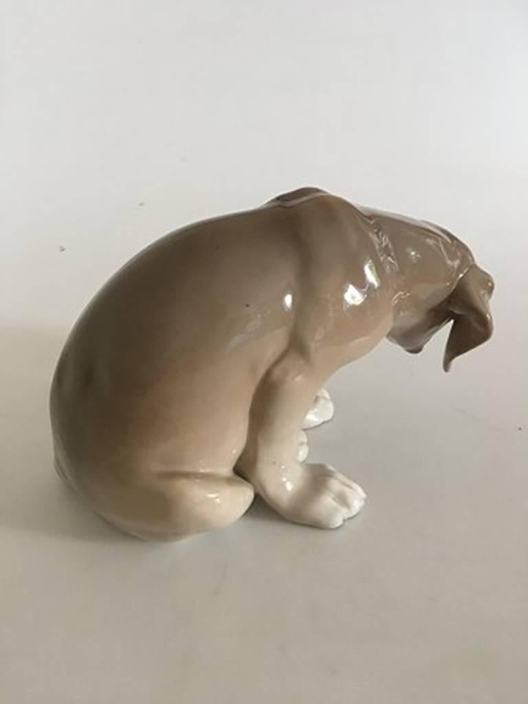 Royal Copenhagen figurine of dog BOB No. 318. The dog has a burning mistake around the one ear. Measures about 14 cm High (5 33/64 in.). From, circa 1889-1922.