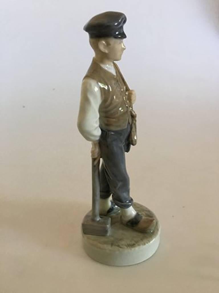Royal Copenhagen figurine of farmer boy with hammer No. 620. Measures: 21 cm H. First quality. In nice whole condition.