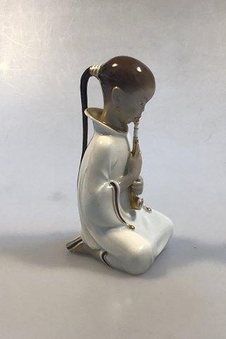 Royal Copenhagen figurine opiumsmoker overglaze no 2342. 

Measures 14cm (5.51 in) Design by Arno Malinowski.