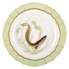 Assiette à poisson Royal Copenhagen avec bord vert, décoration dorée et motif de poisson